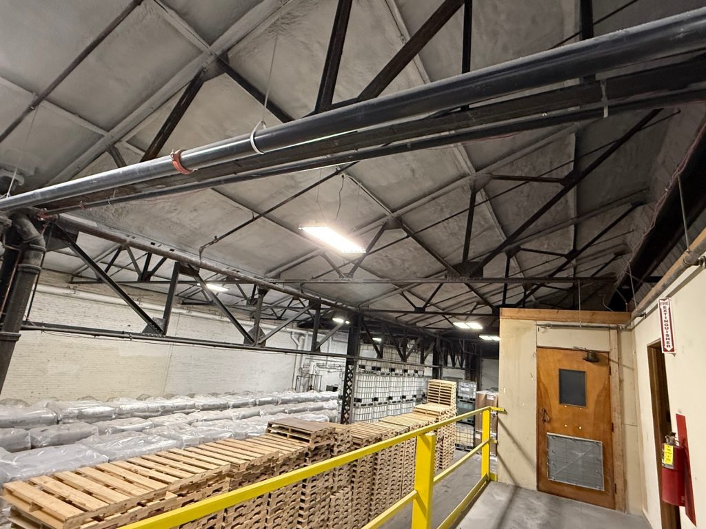 Insulated commercial warehouse with steel roof trusses