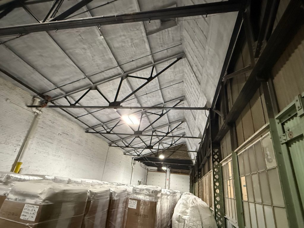 Spray foam insulation on a warehouse ceiling and walls